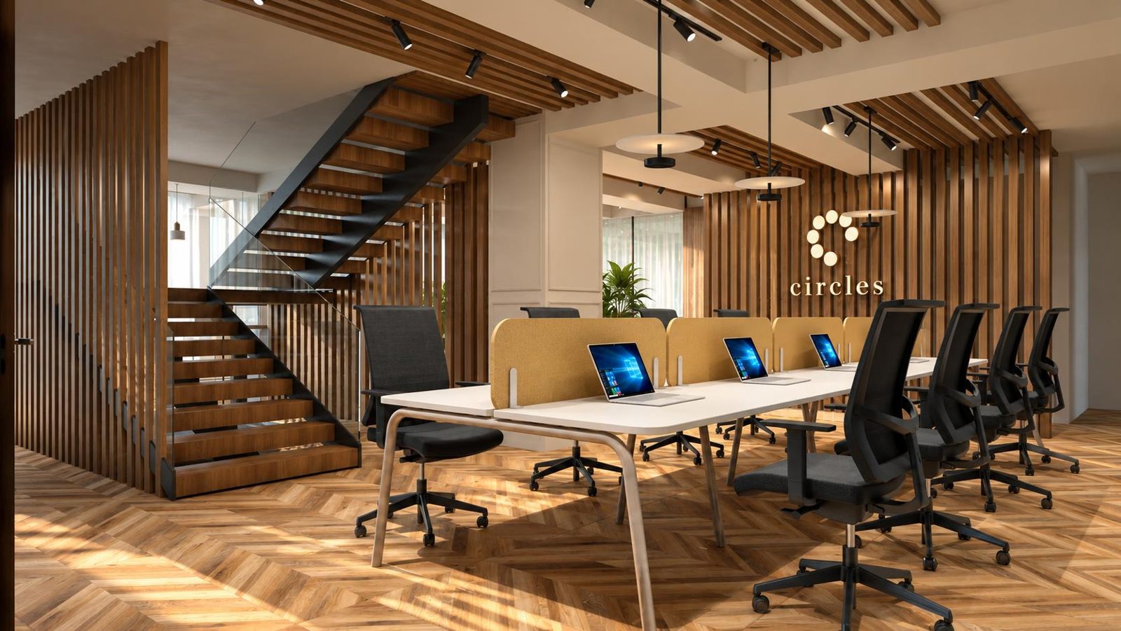 Open desks beneath a timber staircase